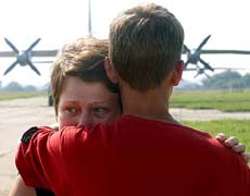 A Ukrainian woman cries on an airfield