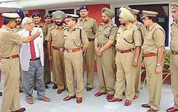 The UT Administrator, Lieut-Gen J.F.R. Jacob (retd), being introduced to the team of police officials who arrested a gang of criminals dealing in fake revenue stamps, in Chandigarh on Tuesday.