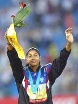 India�s Anju Bobby George, bronze medallist, waves during the medal ceremony