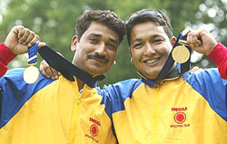 India's Jaspal Rana and Mahaveer Singh display their gold medals