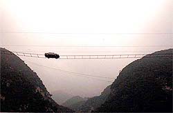 A car driven by Yang Xiangdong runs along a 100-metre-long road