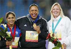 New Zealand's Beatric Faumunia smiles as she wears her gold medal