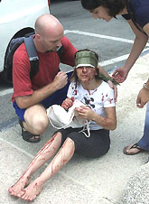 Passers-by attend to a victim of a bomb blast 