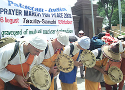 Peace activists bow after crossing the Pakistan-India border