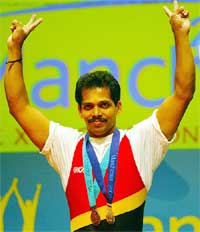 Satish Rai of India celebrates after winning the men's 77 kg weightlifting gold 