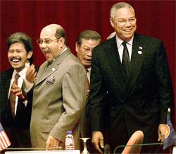 US Secretary of State Colin Powell laughs at a joke