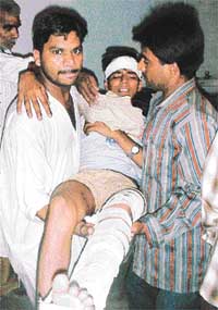 A youth injured in the clash being taken away