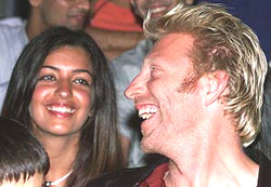 Former German tennis player Boris Becker smiles as he talks with an unidentified woman 