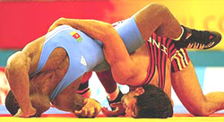 India�s Anuj Kumar bouts with Cameroon�s Jules Kamdem in their men�s 84 kg wrestling heat at the 2002 Commonwealth Games
