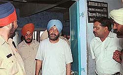 Suspended PPSC Chairman Ravi Sidhu being taken out of the Civil Judge-cum-Judicial Magistrate�s court in Chandigarh.