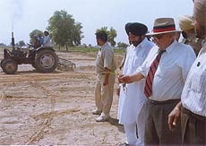 Mr Naib Singh ploughs his dried paddy crop