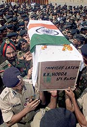 BSF officers carry the coffin containing the body of Commandant