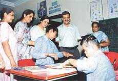The Deputy Commissioner, Mr Anurag Aggarwal, looks on, as some mentally challenged children of Ek Prayaas 