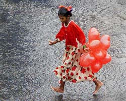 A girl runs to take cover from the rain