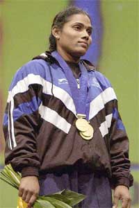 India's Shailaja Pujari poses with her three gold medals