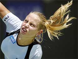 Jelena Dokic of Yugoslavia serves to Anna Kournikova