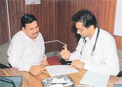 Dr K.S. Behgal, Global Cancer Concern India, checks a patient