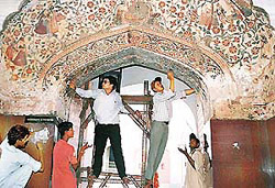 Assistant archaeology chemists of the Archaeological Survey of India begin restoration work at Singh Dwaar at Mansa Devi temple, Panchkula, on Tuesday.