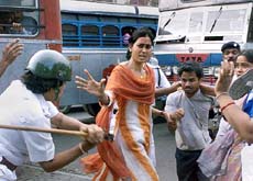A policeman swings a baton at socialist activists during a demonstration in Kolkata on Tuesday.