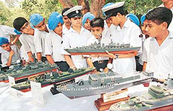 Students look at ship replicas displayed by cadets of 1 Chandigarh Naval Unit NCC 