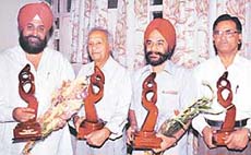 Padmashree Nek Chand, Dr S.S. Bhatti and Col R.K. Singh with PWD Minister (B&R), Mr Pratap Singh Bajwa, during an award giving function organised at the Chandigarh Press Club on Friday.