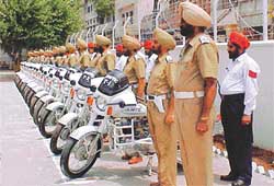 Ttraffic cops stand beside their motor cycles at the newly set up police station