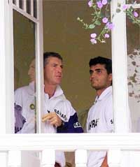 Indian captain Saurav Ganguly (right) and coach John Wright look from their dressing room