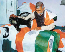 A 75-year-old man stitches tricolours for the Independence Day celebrations.
