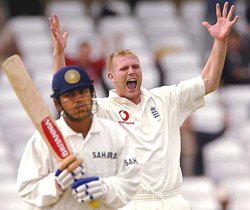 England bowler Mathew Hoggard (R) celebrates taking the wicket of India's Virender Sehwag