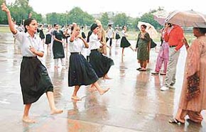 Schoolchildren carry out preparations for the Independence Day celebrations in pouring rain in Chandigarh on Tuesday.