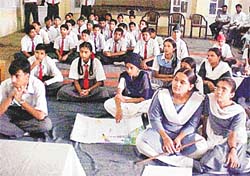 Participants in students� science seminar listen to a speaker at New Secondary School