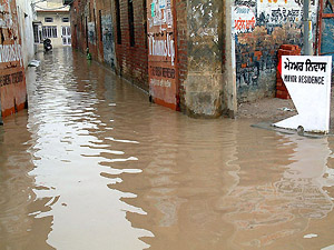 Ankle-deep water outside Amritsar Mayor Sunil Datti�s residence at Chheharta after torrential rain on Monday evening.
