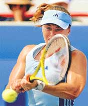 Martina Hingis of Switzerland returns a shot from Spain's Magui Serna during the first round of the Rogers AT&T Cup