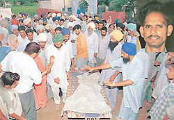 Villagers and relatives of Hardev Singh and Lakhwinder Singh, who were strangled by their father, receive the bodies for cremation at Khurd Raipur village near Sohana on Thursday and (inset) Baldev Singh, father of the children.