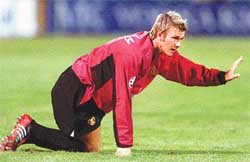 David Beckham of Manchester United kneels during their Champions League third round qualifying soccer match 