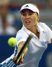 Martina Hingis of Switzerland stretches to hit a return