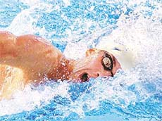 Michael Phelps of the North Baltimore Aquatic Club sets a new world record