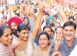 Hurrah!: Jubilant DMCH employees flash the victory sign after reaching an agreement with the management in Ludhiana on Saturday. 