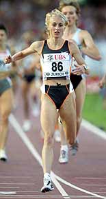 Gabriela Szabo of Romania crosses the finish line