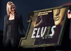 Priscilla Presley, the former wife of Elvis Presley, looks over at the newly unveiled cover of the Elvis Presley album