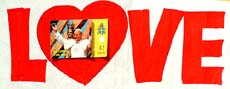 A picture of Pope John Paul II is attached to a poster