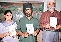 (From left) Ms Aman Sidhu, Mr Inderjit Singh Jaijee and Dr Gurmit Singh release booklet "Debt Trap --- Don�t Kill Yourself, Don�t Sell Your Land, Go to the Court" in Chandigarh on Sunday.