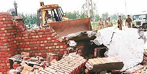 The enforcement wing of the Panchkula administration demolishes a structure of Shalimar Estate, a housing colony, in Alipur village along the Panchkula-Naraingarh road near Barwala on Sunday.