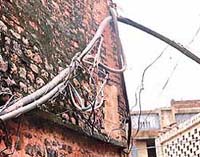 Electricity wires hang hazardously on walls of houses at Hargobindpura locality of Mani Majra in Chandigarh.