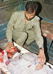A policeman examines the body