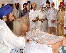 Residents of Pul Kanjri village perform ardaas
