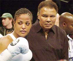 Laila Ali poses with her father former boxing great Muhammad Ali