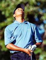 Tiger Woods reacts after making a bad tee shot on the 17th hole during third round play
