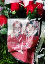 A floral display along with a picture of missing ten-year-old schoolgirls