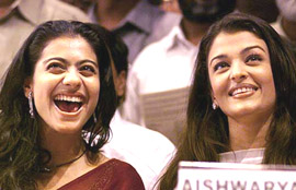 Film actress Kajol laughs as former Miss World and Bollywood star Aishwarya Rai looks on